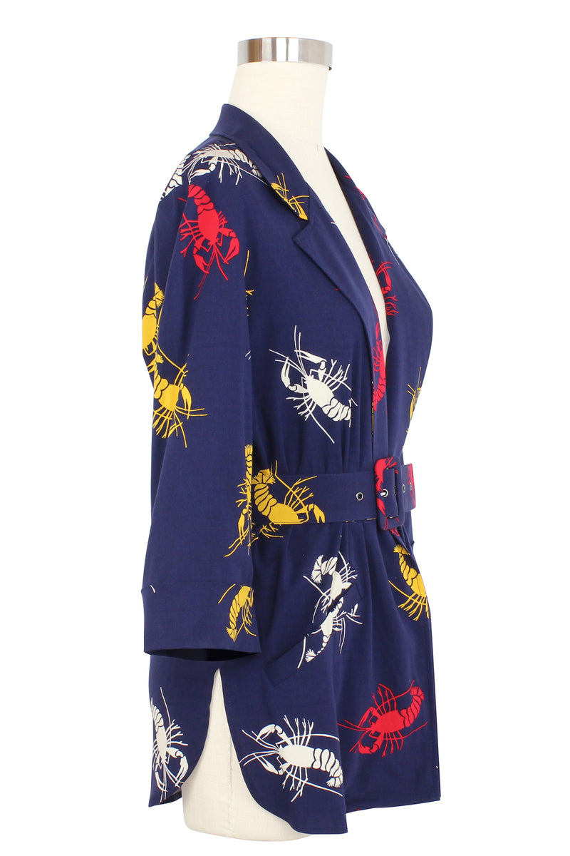 The 1980's / 90's inspired Heather Blazer is a perfect piece to wear open, crossed over, or cinched closed as a blouse with its matching removable belt. Great details on this style include-patch pockets on the front, sleeves lined to be cuffed to your liking, and in a slightly oversized relaxed fit in the new Crawfish print, a 1930s/40s novelty print of red, yellow, and white crustaceans on a deep navy blue background as a nod to Schiaparelli's lobster.