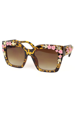 These Iconic Flower Square Sunglasses are the perfect blend of vintage and modern. The heavy floral pink and gold details add a touch of elegance to the classic square shape. Shield your eyes in style and make a bold fashion statement with these sunglasses.