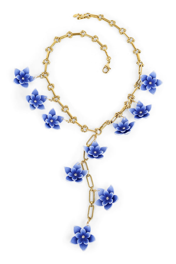 An extra special piece by Yochi! Handcrafted in New York, the Blue Flower Necklace features a dangling 22k gold plated brass lariat of blue flowers cascading from the neck down.