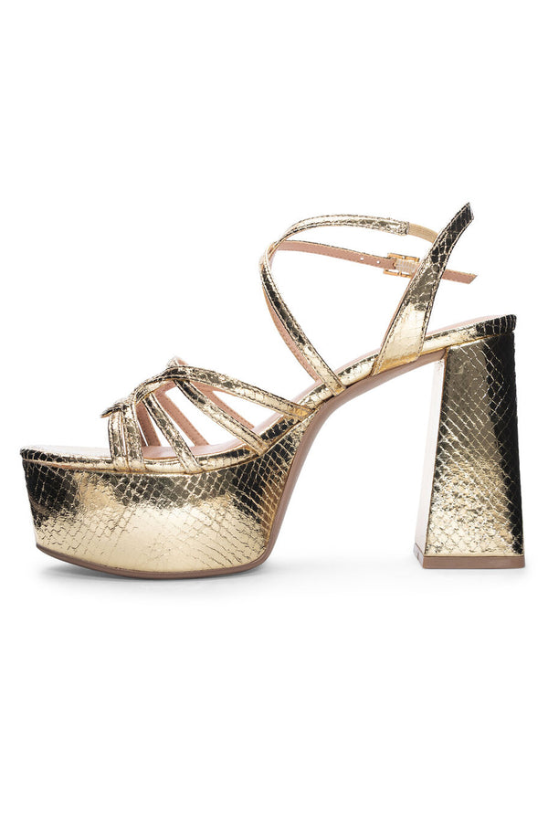 Slender straps and an embossed metallic upper create visual intrigue on a retro-inspired sandal with a funky gold snakeskin look platform and block heel.