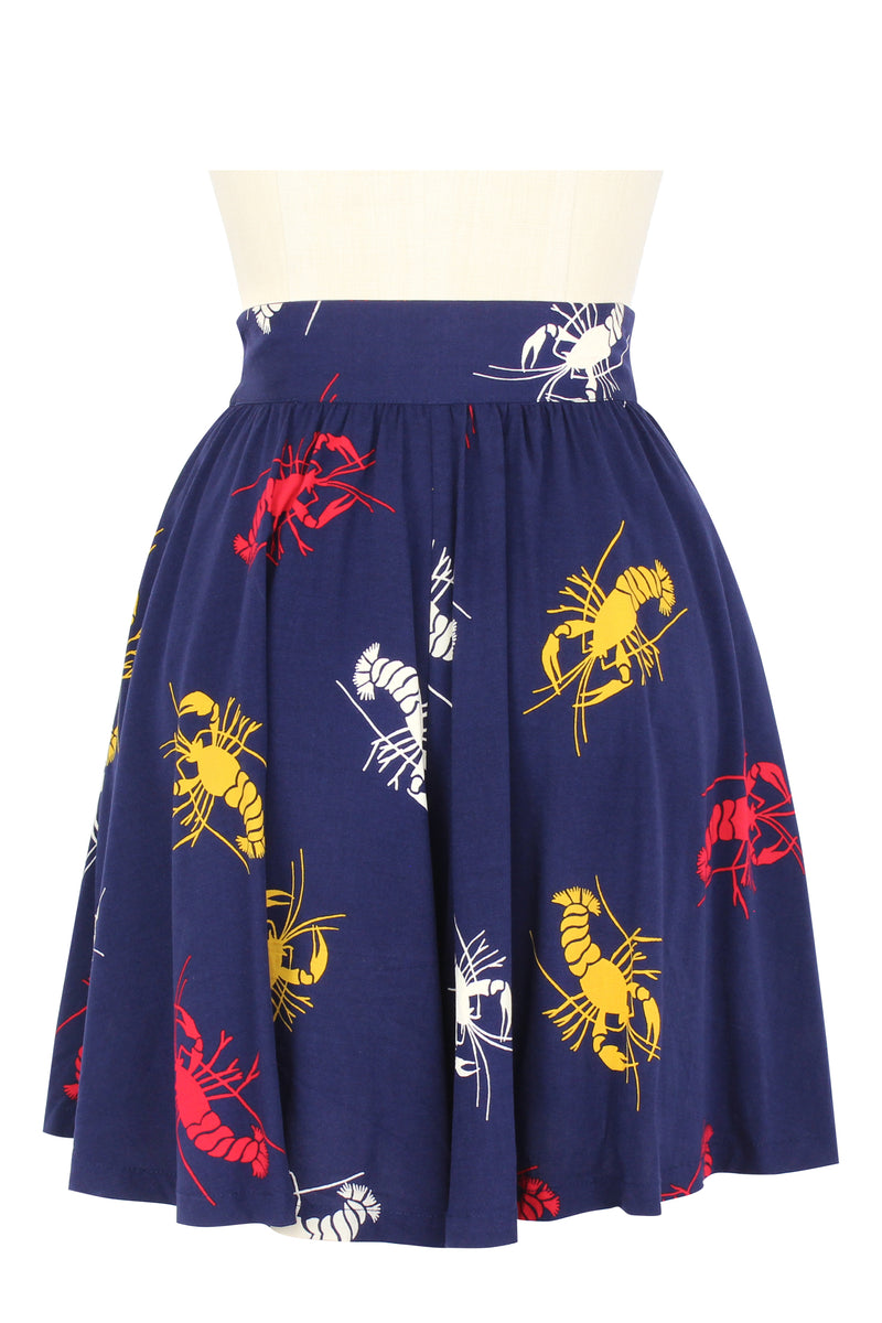 Modeled after breezy and loose shorts of the 1930s, these High Waist Shorts are a brand staple, as the best cross between a mini skirt and tap short featuring a mid-thigh length, a high fitted straight waistband, and a side pocket in the new Crawfish print, a 1930s/40s novelty print of red, yellow, and white crustaceans on a deep navy blue background as a nod to Schiaparelli's lobster.