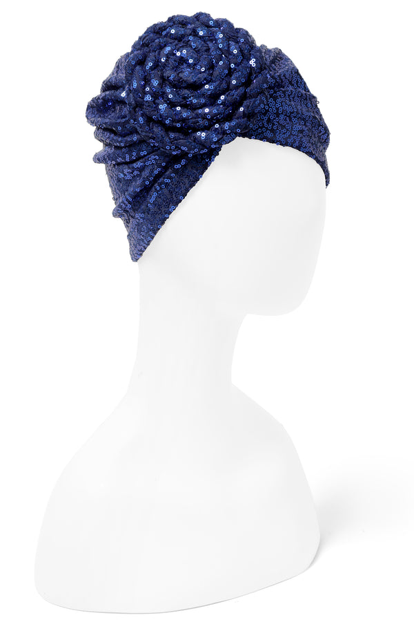 Great with caftans, the Yves Dress, and more! Finish your look with a sequin embellished stretch turban featuring a premade statement rosette for easy glamour-to-go.  One of many hues, this listing is for the deep royal blue sequin rosette turban.