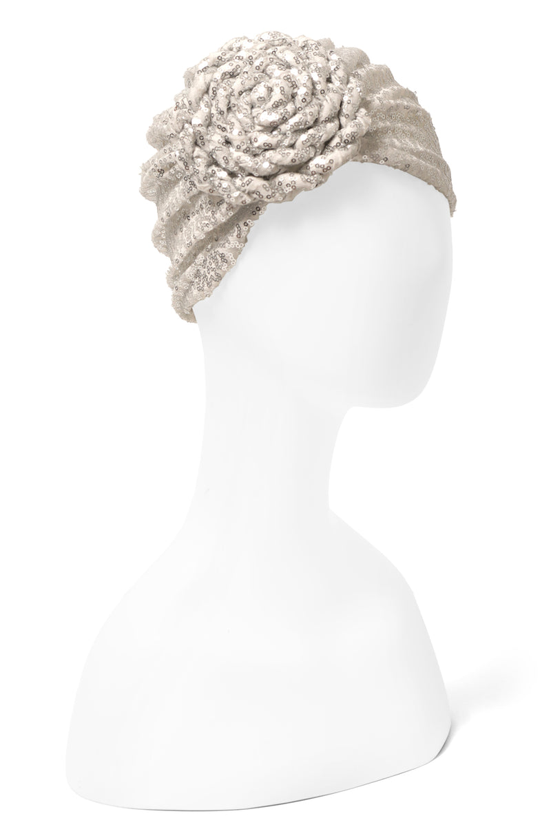 Great with caftans, the Yves Dress, and more! Finish your look with a sequin embellished stretch turban featuring a premade statement rosette for easy glamour-to-go.  One of many hues, this listing is for the silver sequin rosette turban.